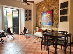a living room with a couch and a table and chairs at Amazing experience in Casco Viejo historical site1 in Panama City