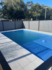 a swimming pool in a backyard with a fence at 3 Seacrets at Shelly in Urangan