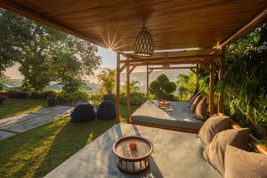 a room with a bed and a table at The Acala Shri Sedana in Nusa Lembongan