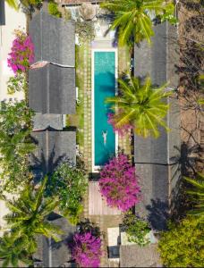 an overhead view of a house with a blue door at Palmeto Village in Gili Trawangan