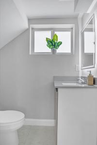 a bathroom with a toilet and a sink and a window at Sistrunk Shades Villas #3 - Brand New Townhomes Downtown Fort Lauderdale in Fort Lauderdale +19 photos