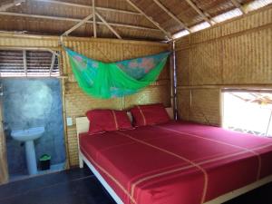 a bed in a small room with a sink and a bed at Palm Garden Bungalows in Ko Lanta
