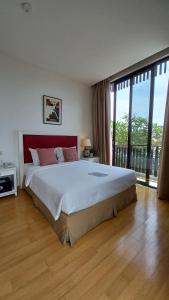 A bed or beds in a room at White Tree Residence