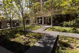 a walkway in front of a building with trees at 304 San Lorenzo in Mar del Plata