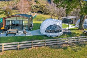 a camping site with a tent and a picnic table at Black Label Retreats in Gisborne