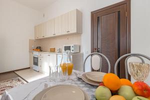 a kitchen with a table with fruit on it at Уютная Квартира Expo Boulevar in Astana