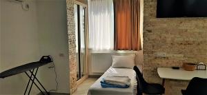 a small room with a bed and a window at "Vera old City" in Tbilisi City