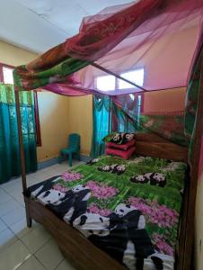 Ένα ή περισσότερα κρεβάτια σε δωμάτιο στο Agus Family Homestay