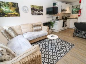 a living room with a couch and a table at Villa No 50 in Lanteglos