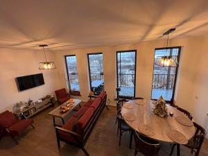a living room with a table and chairs at Green Agarak Guest House near Dendropark, Stepanavan in Gyulagarak