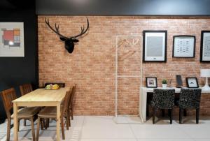 a dining room with a brick wall at Huzi Room in Tainan