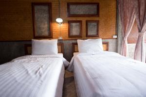 Postel nebo postele na pokoji v ubytování Herntai Resort Maelanoi
