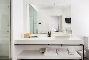 a white bathroom with a sink and a mirror at The Stirling Hotel in Stirling