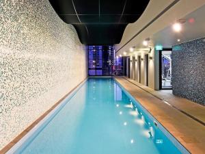 a swimming pool in a building with a building at Southbank Apartment with Skyline View: 5-Min Walk to CROWN Casino in Melbourne