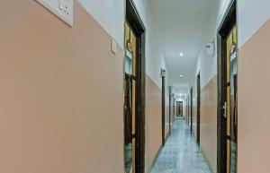 a hallway with a long corridor with doors on the walls at Collection O Hotel Ns Sheetal in Raipur