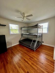 ein Schlafzimmer mit einem Etagenbett und einem Deckenventilator in der Unterkunft Cozy Cul de Sac Maryland Home near FedEx Field in District Heights