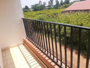 a balcony with a black railing and a view of a field at Zuri Cosy Apartment in Busia