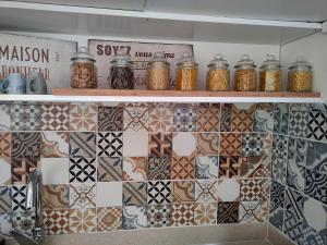 a kitchen with a bunch of different types of tiles at Maison de vacances in Bias