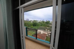 a window with a view of a city at BNB RESIDENCE MOUNT LAVINIA 1 in Mount Lavinia