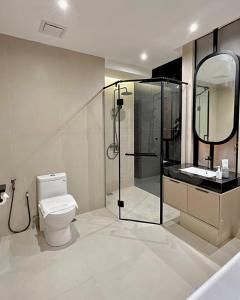 a bathroom with a shower and a toilet and a sink at I-VISTA HOTEL in Tawau