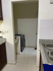 a small kitchen with a sink and a washing machine at Apartamento Amplio en Residencial de 2 Habitaciones in Mendoza