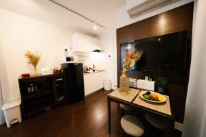 a living room with a table with a bowl of fruit on it at FL Residence Shinjuku Kawadacho in Tokyo