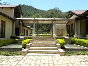 a set of stone steps leading to a building with a gate at Dawsons Game Lodge in Badplaas