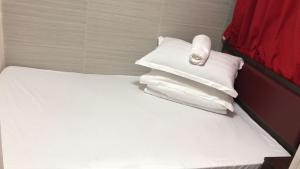 A bed or beds in a room at 金源賓館 Golden Yuan Guest House