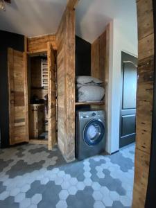a laundry room with a washing machine in a room at Greenspot - Loft with 2 bedrooms and free parking in Liepāja