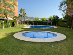 una pequeña piscina en medio de un patio de césped en Arruzafa Home, en Córdoba
