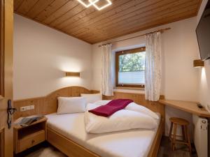 a small bedroom with a bed with a window at Appartement Bergblick in Brixen im Thale