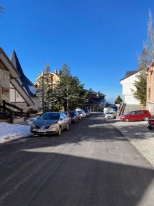 a street with cars parked on the side of the road at Acogedor Apartamento en Sierra Nevada in Sierra Nevada