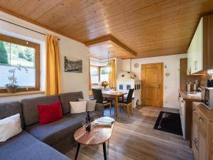 a living room with a couch and a table at Appartement Bergblick in Brixen im Thale