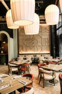 a restaurant with wooden tables and chairs and chandeliers at The Interlude in Melbourne