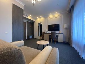 a living room with a couch and a table at Aura Hotel & Spa in Vologda