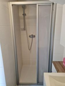 a shower with a glass door in a bathroom at StayEasy Apartments Ramingtal #1 