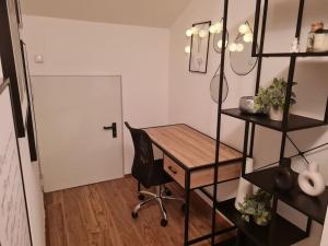 a room with a desk and a chair and a door at StayEasy Apartments Ramingtal #1 