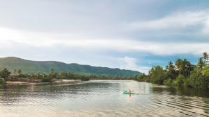 a person in a boat on a river at Sabay Beach in Kampot