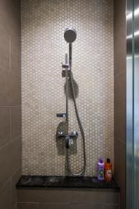 a shower in a bathroom with a tile wall at Lucentia Residence At Kuala Lumpur By Dreamcloud in Kuala Lumpur