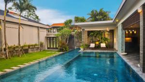 a swimming pool in the backyard of a house at Alindra Villas & Spa in Nusa Dua