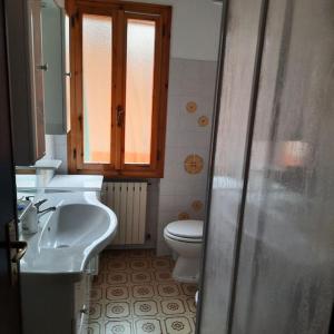 a bathroom with a sink and a toilet at Rilassati al Corno alle Scale in Vidiciatico