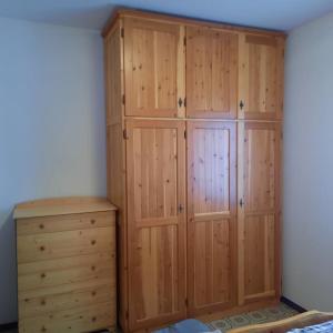a large wooden closet with a dresser in a room at Rilassati al Corno alle Scale in Vidiciatico +3 photos