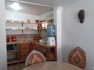 a kitchen with a table and a blue mixer at Room in Lodge - Valparaluz House, 2 People, Private Bathroom no1641 in Valparaíso