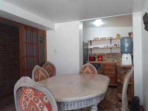 a dining room with a table and chairs in a kitchen at Room in Lodge - Valparaluz House, 2 People, Private Bathroom no1641 in Valparaíso