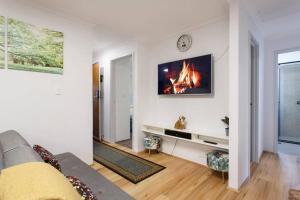 a living room with a fire in the wall at Luxe 3BR Villa with Kitchen & Laundry in Perth