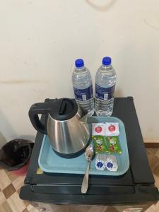a tea kettle and two bottles of water on a stove at Baga Beach Prime in Baga