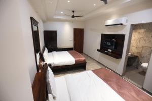 Un ou plusieurs lits dans un hébergement de l'établissement Chandan Kasturi Resort