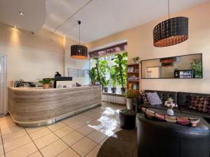 a lobby of a restaurant with a counter at Hotel Sendlinger Tor in Munich