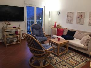 a living room with a couch and chairs and a tv at Apartment Simo in Herceg-Novi