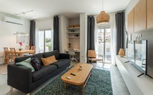 a living room with a couch and a table at Kition City Apartments in Larnaca